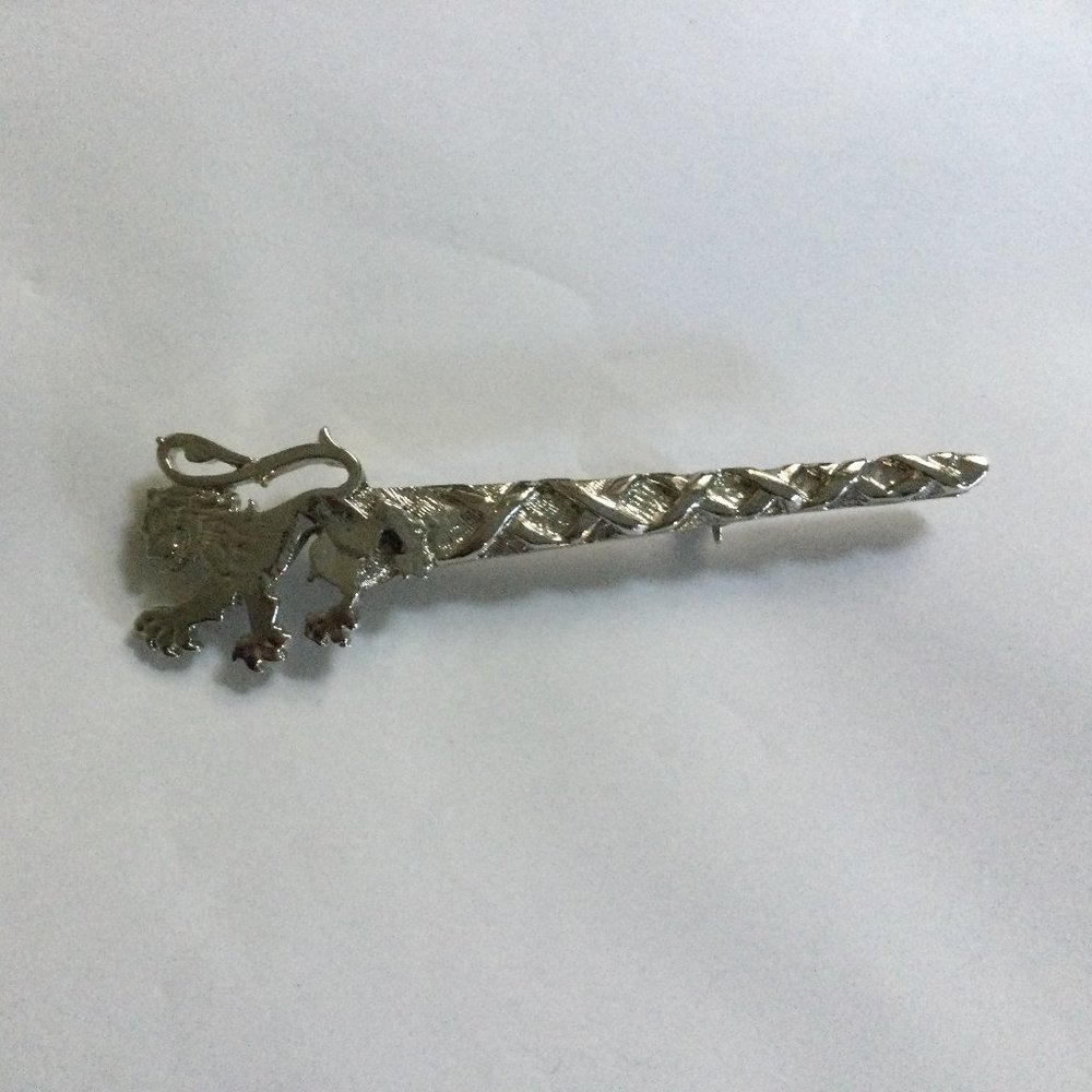 Silver tone metal pin brooch lion?